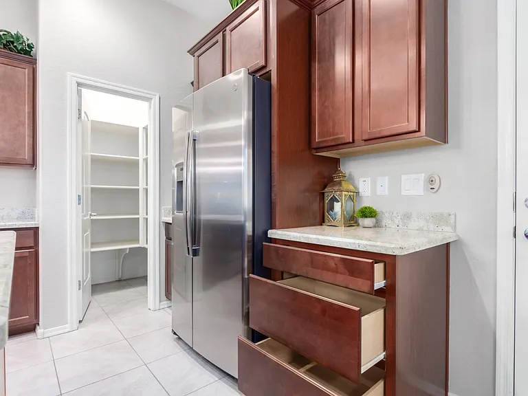 Fridge is included as shown. Pots and pans drawers custom cabinets layout and a key drop counter.