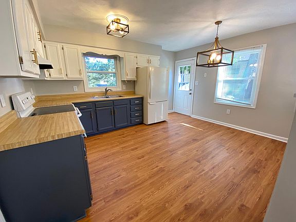 Eat in kitchen with new floors, paint, lighting.