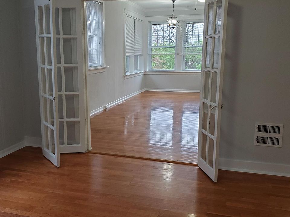 View from middle room looking into the front room, with glass french doors.