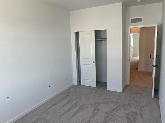 Second upstairs bedroom, view of the closet and door next to the loft