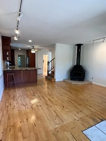 Open concept living room, kitchen, and dining nook (fireplace is not operational) but home has heating and A/C