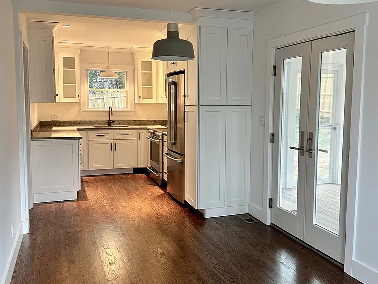 Kitchen with French doors to screened in three season porch.