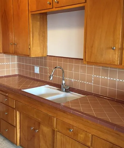 Natural Swedish birch modern cabinets and custom hand tiling. So many cabinets on the other side as well and broom closet in corner.