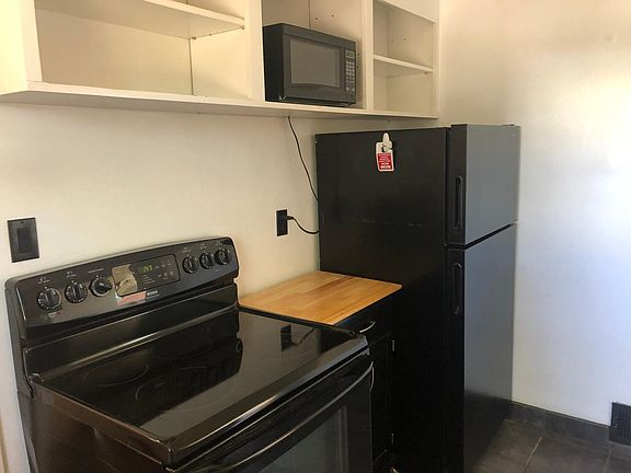 small kitchen, nice appliances with storage on wheels. Microwave stays.