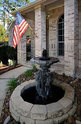 FRONT ENTRY FOUNTAIN. AND CONCRETE URN TO REMAIN WITH HOME. 5 ZONE SPRINKLER SYSTEM AND DRIP SYSTEM 
