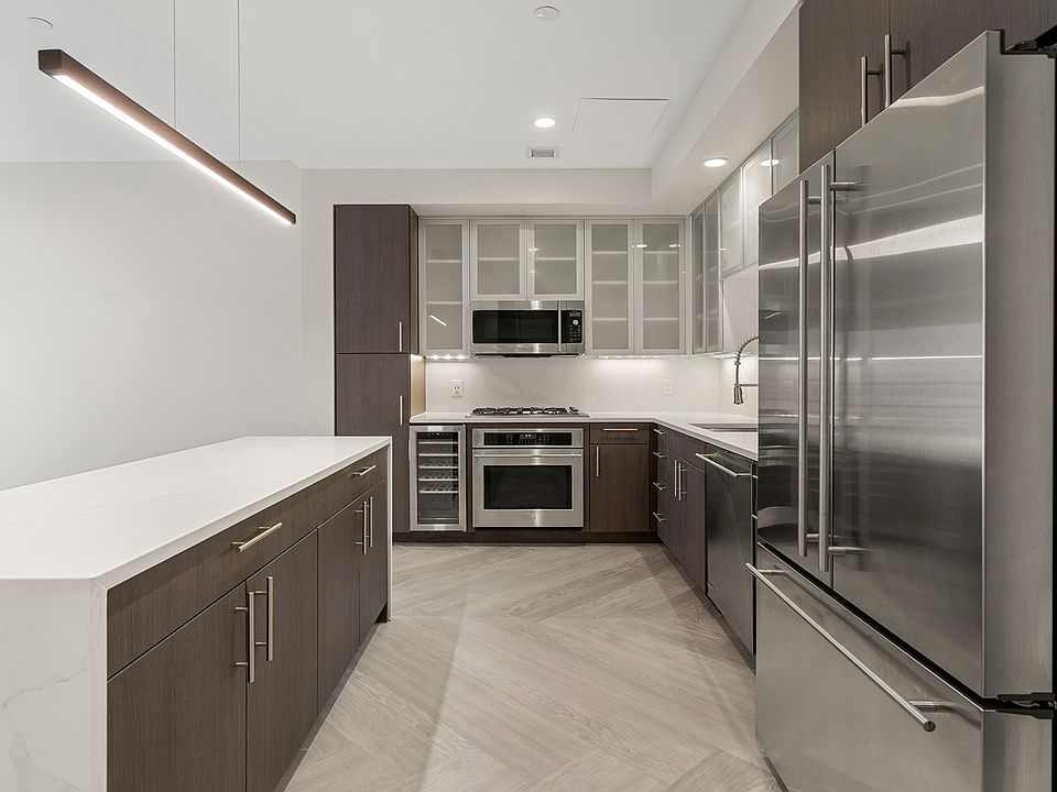 Brand-new kitchens feature stainless steel appliances, two-tone modern cabinets and quartz countertops