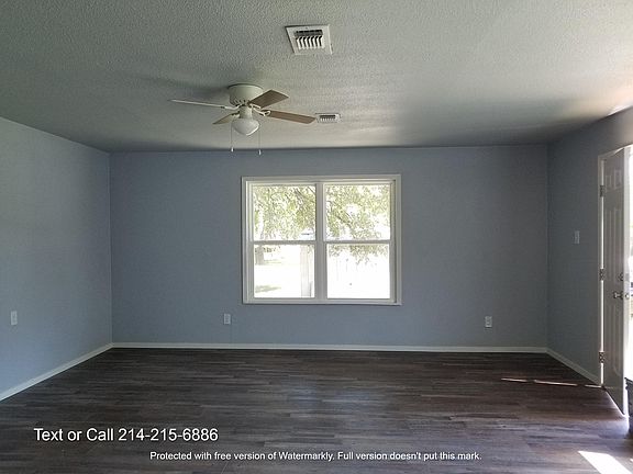 Large master bedroom with ceiling fan and plenty of windows for natural light!