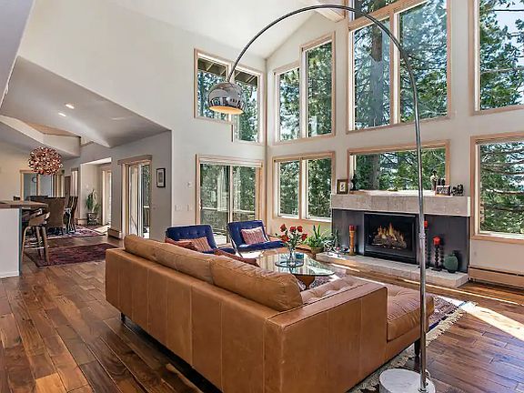 Main living space - with fireplace and floor to ceiling windows.