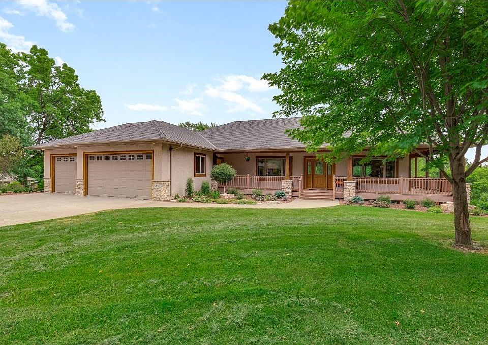 Exquisite Prairie-style walkout rambler in Rosevile! 2 garages (lower-level spancrete garage) on 0.5 acre lot!