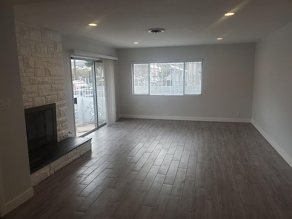 Living room with fireplace and patio access.