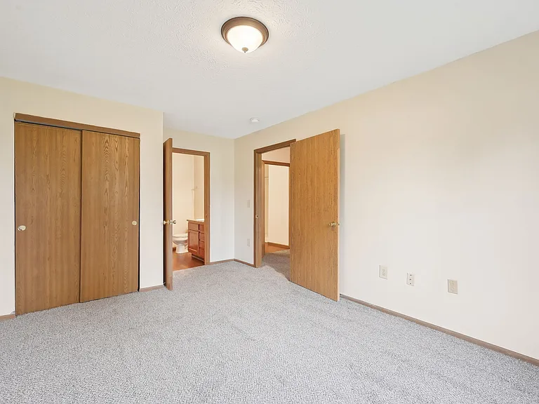Dooley's Orchard apartment showing bedroom with a connected bathroom.