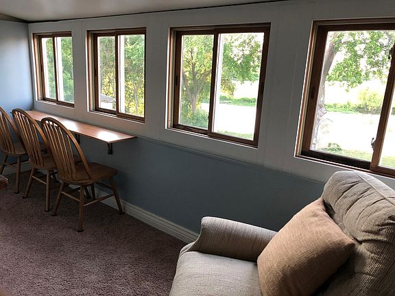 Sun room with recliner and bar where you can eat or drink and watch the river.