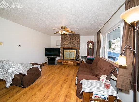 Living Room w/ wood burning fireplace.