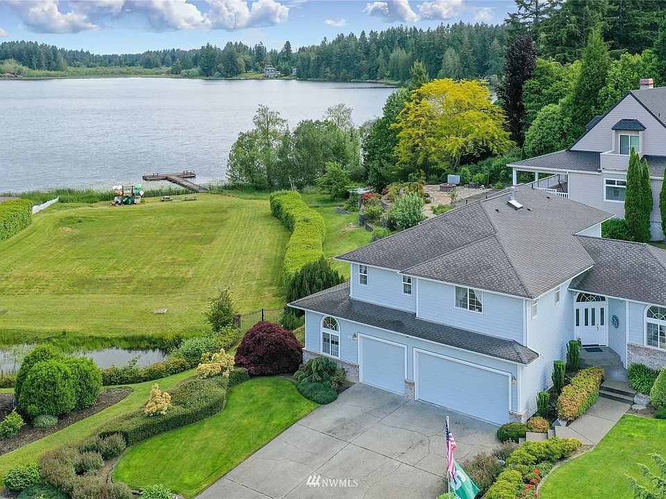Drone view of the home (on right front) next to neighborhood boat launch with incredible views of Pattison Lake.>
