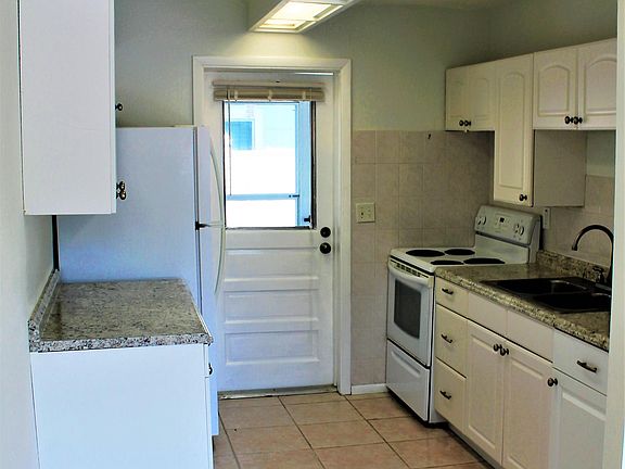 Updated kitchen with new counter tops.  Through that back do