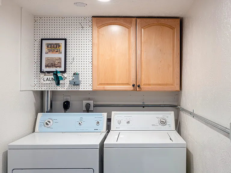 Private laundry room with washer and dryer