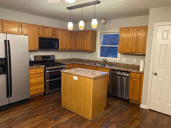 Updated appliances (includes fridge, oven, stove, microwave and dishwasher), island and window over the sink.