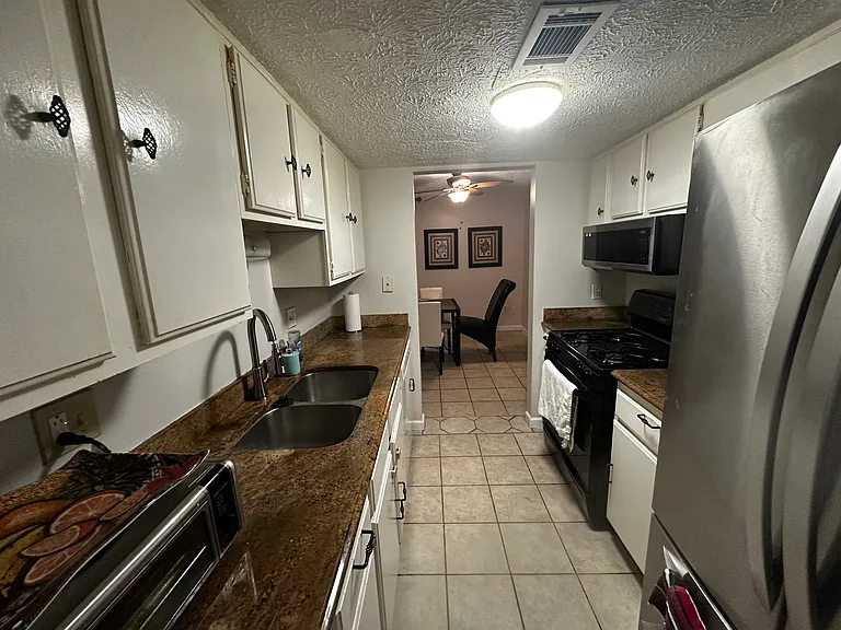 Kitchen wider view from front entrance. You can see the airfryer on the left.