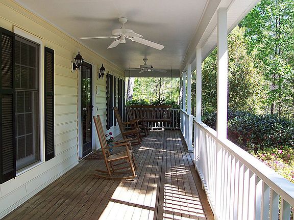 Beautiful rocking chair front porch with ceiling fans. 