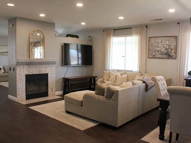 Spacious living area with decorative fireplace