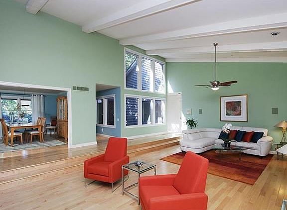 The dramatic and open great room has so many windows.  This perspective faces the interior courtyard with a water element and is accessible to the dining room.