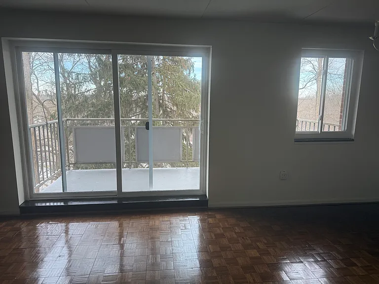 Living room, balcony, and entrance to dining area.