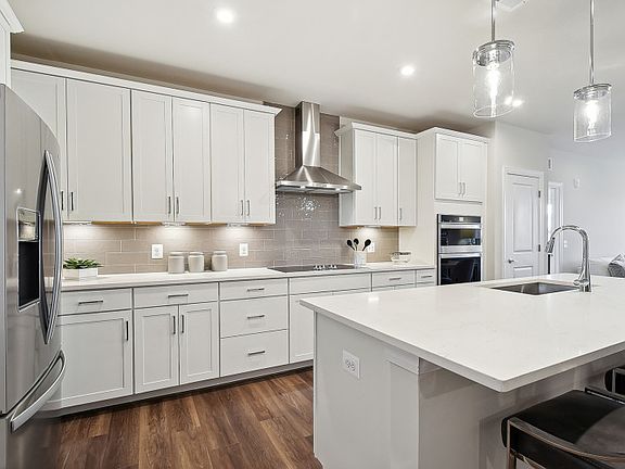 White Cabinetry and Quartz Countertops in the Gourmet Kitchen