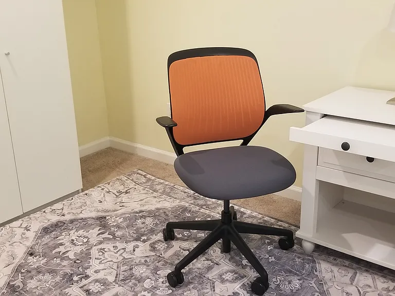 A small tabletop pulls out of the nightstand to accommodate a laptop for an an impromptu work area in the second bedroom