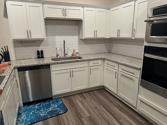 Updated kitchen with large island and convection stove, filtered water tap, and a microwave oven with an air fryer setting. Lots of cabinet storage.