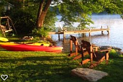 Kayaks, 4 total. Also a canoe and rowboat.
Firepit and Wood Swing on left.
This photo only shows 1/2 of front lawn.