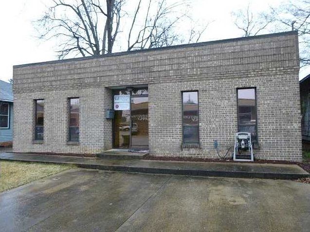 Front elevation with two paved parking spots