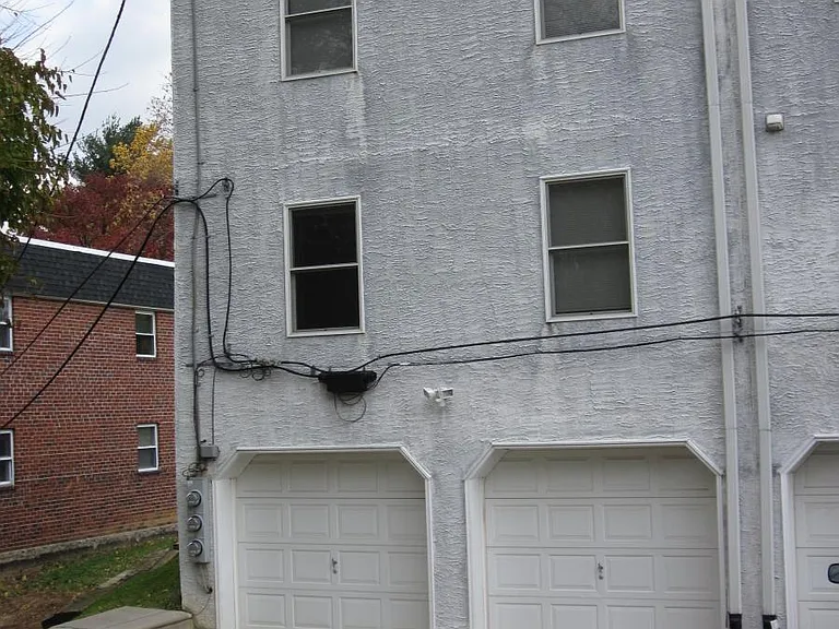 One garage with parking behind it.