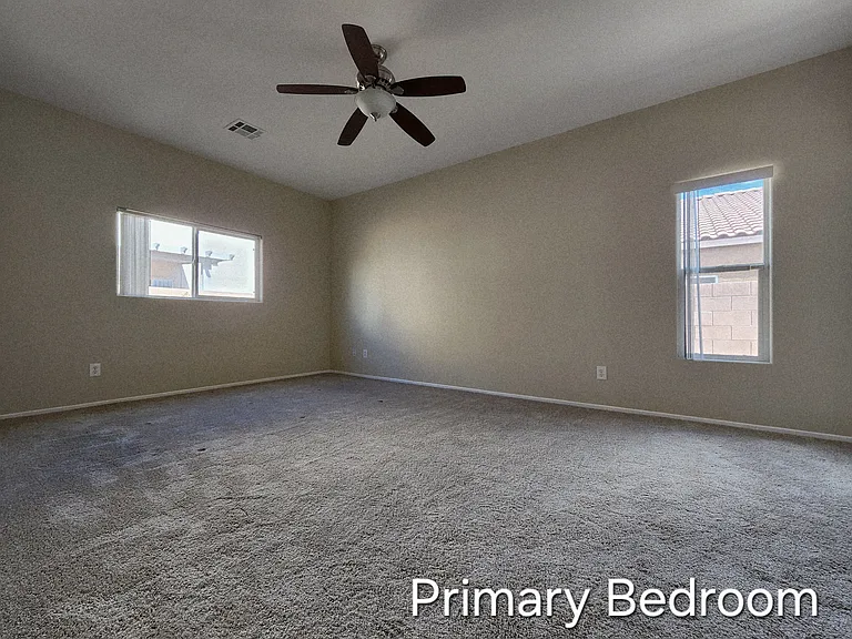 Private primary bedroom with ceiling fan and light