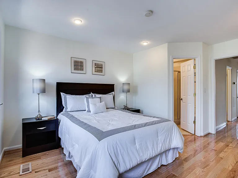 Larger bedroom with hardwood floors and en-suite bathroom.
