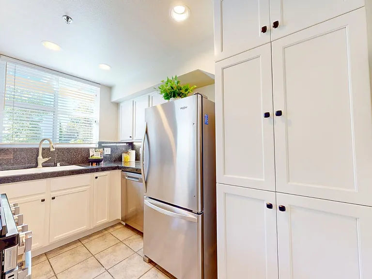 Kitchen. New cabinetry. Stainless steel appliances. Gas stove. Granite counters. Tiled floors.