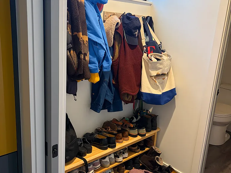 Small mudroom behind the kitchen provides additional storage. It is also connected to a half-bath on the ground floor level.