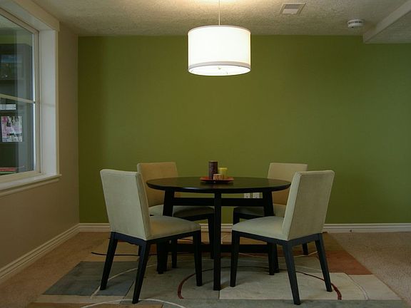 Asian-style round dining table with comfortable, upholstered chairs
