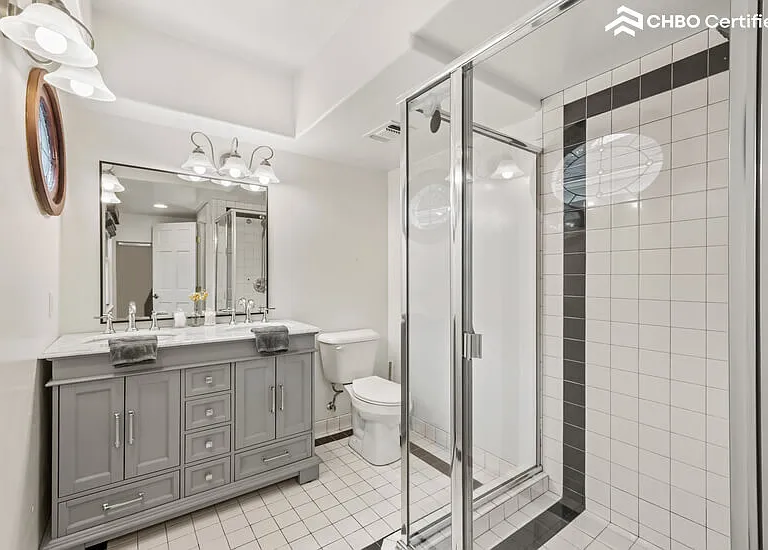 Upstairs primary ensuite bathroom with double sinks & shower