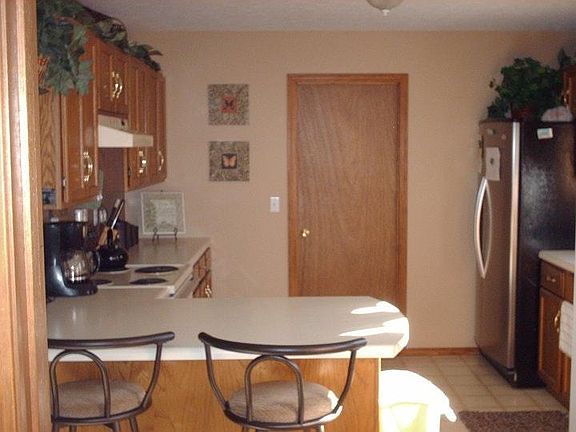 Kitchen facing door to bonus room. Fridge belongs to residen