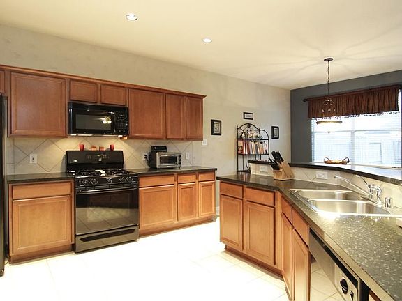 KITCHEN - Bright with tons of cabinet and counter space! Great appliances and is like new! This immaculate kitchen is truly any chefs dream.