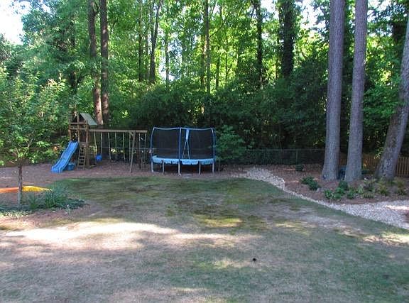 Backyard with playset included, trampoline not included.