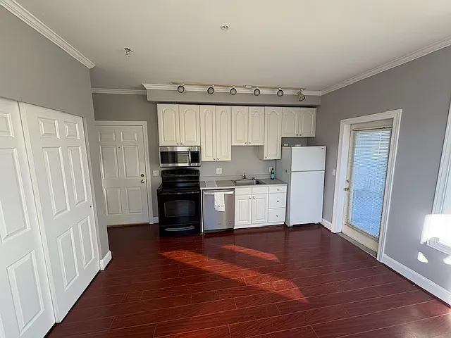 Kitchen has stainless steel appliances and includes a dishwasher