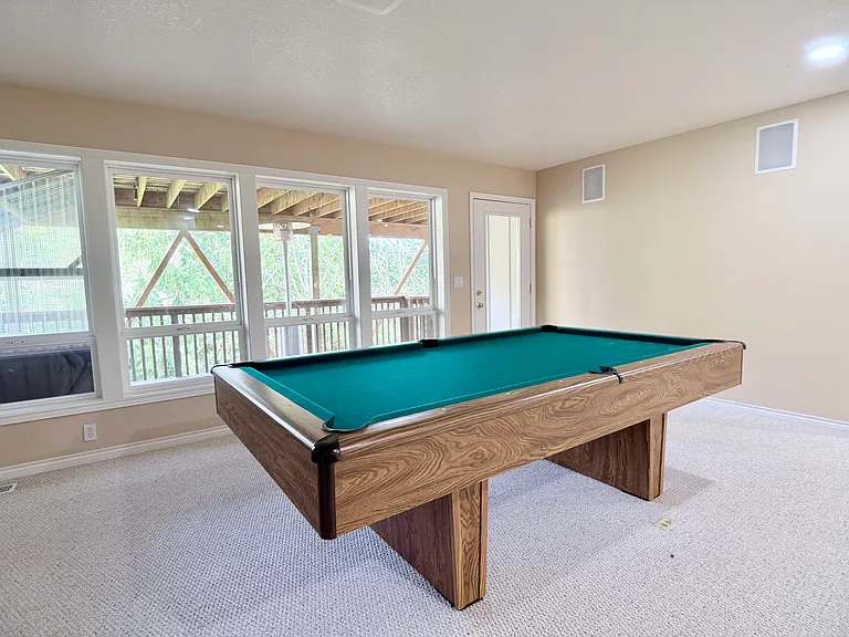 Full-size pool table complete with cue sticks; also included (not pictured) are a table brush and protective cover.