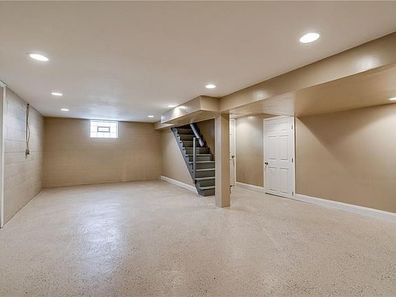 Large Finished basement with 5 doors leading to the garage, storage area, laundry area, mechanical area and updated half bath.