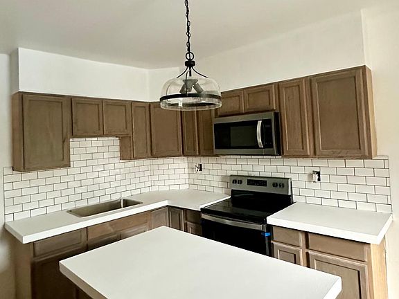 Kitchen shown is for unit 43. Unit 41 has white kitchen cabinets with the same backsplash.