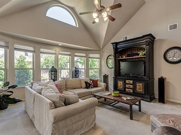 Great room with wall of windows overlooks the beautifully landscaped backyard.