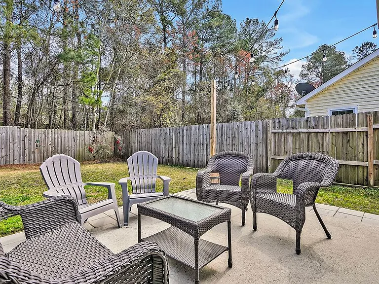 Privacy fenced in backyard and patio. Flower pots with posts and sting lights included.