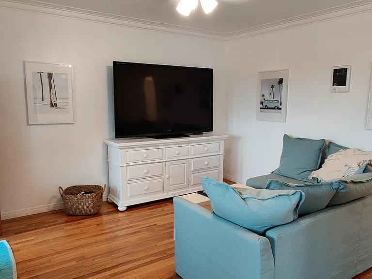 Living room with hardwood flooring. Upstairs unit.