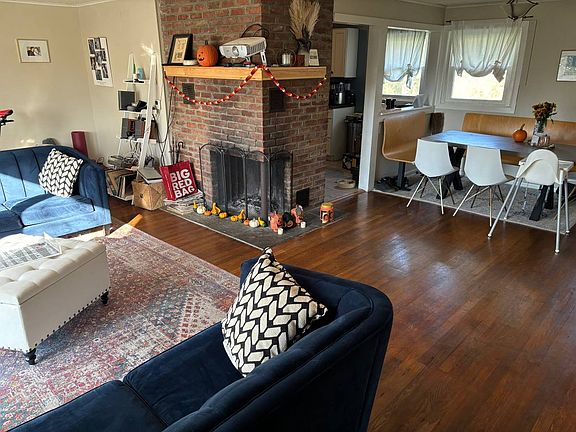 Open living room with fireplace and dining area - dining area is next to kitchen