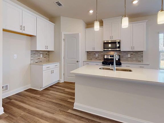 A large kitchen island anchors the open-concept floorplan.